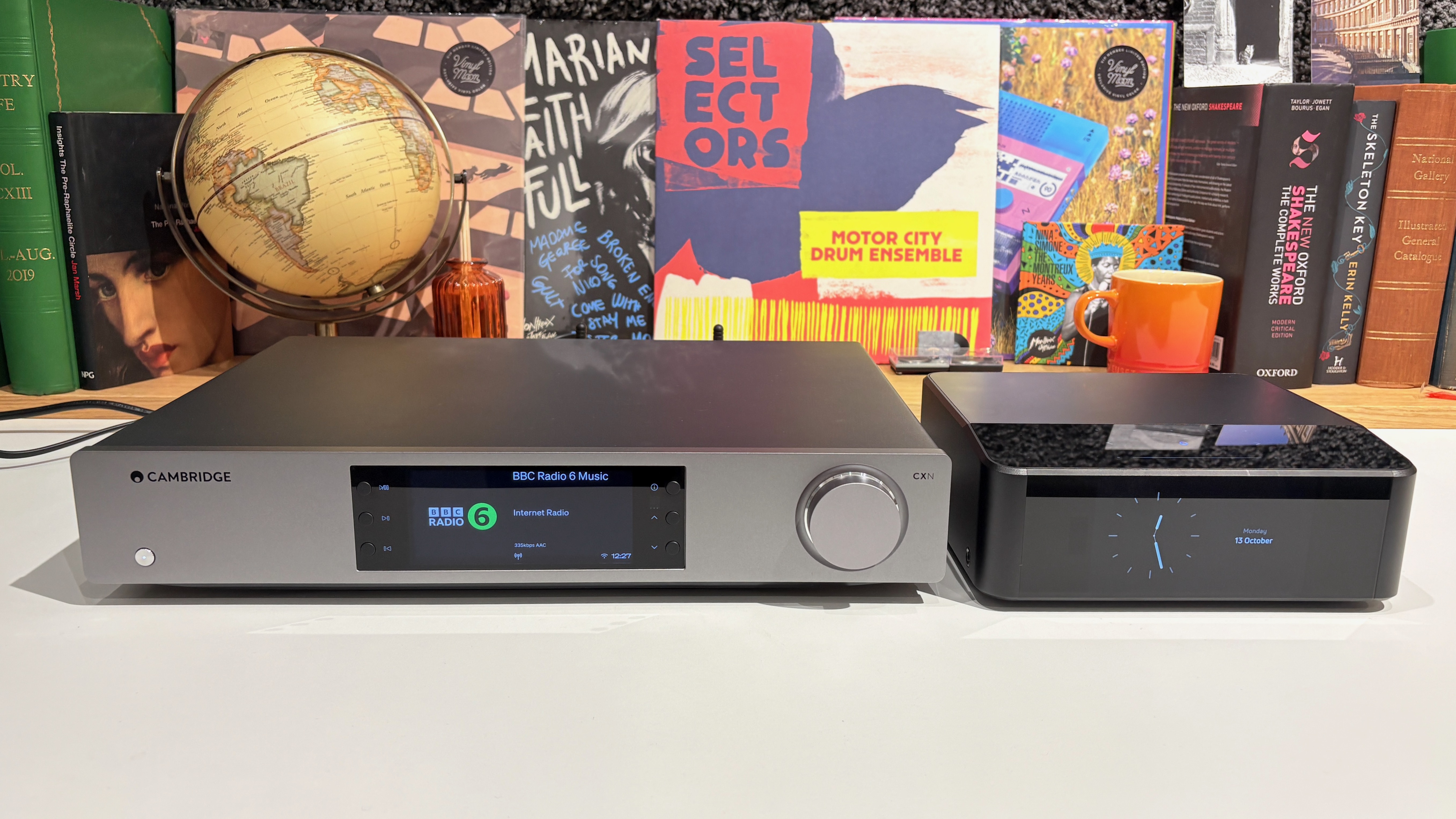 Bluesound Node Icon and Cambridge Audio CXN100 streamers placed next to each other on a white desk