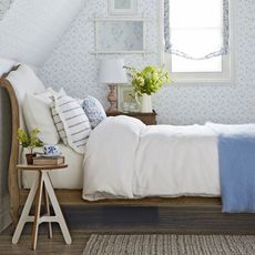 attic bedroom with bed wooden bedside table