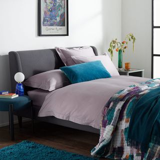 purple bedding in a white bedroom