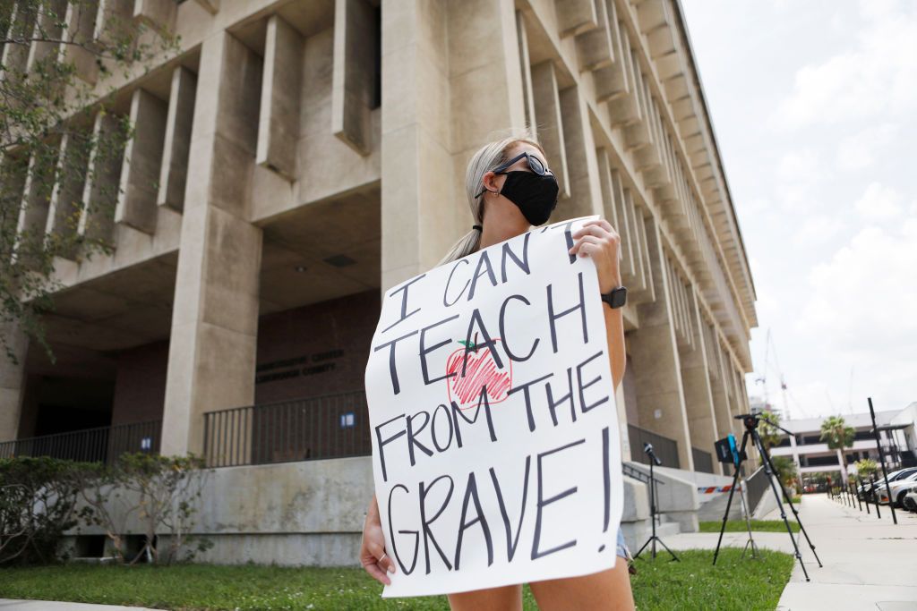 A teacher protests against reopening schools in Florida.