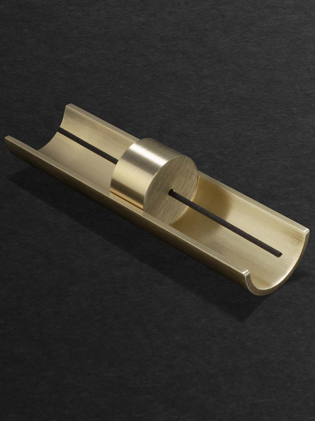 A curved incense holder in brushed gold from Cinnamon Projects