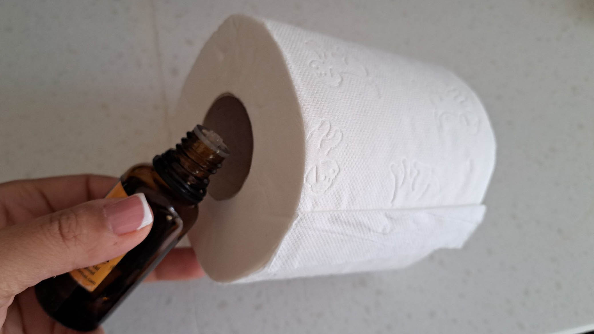 Essential oil drops inside toilet roll