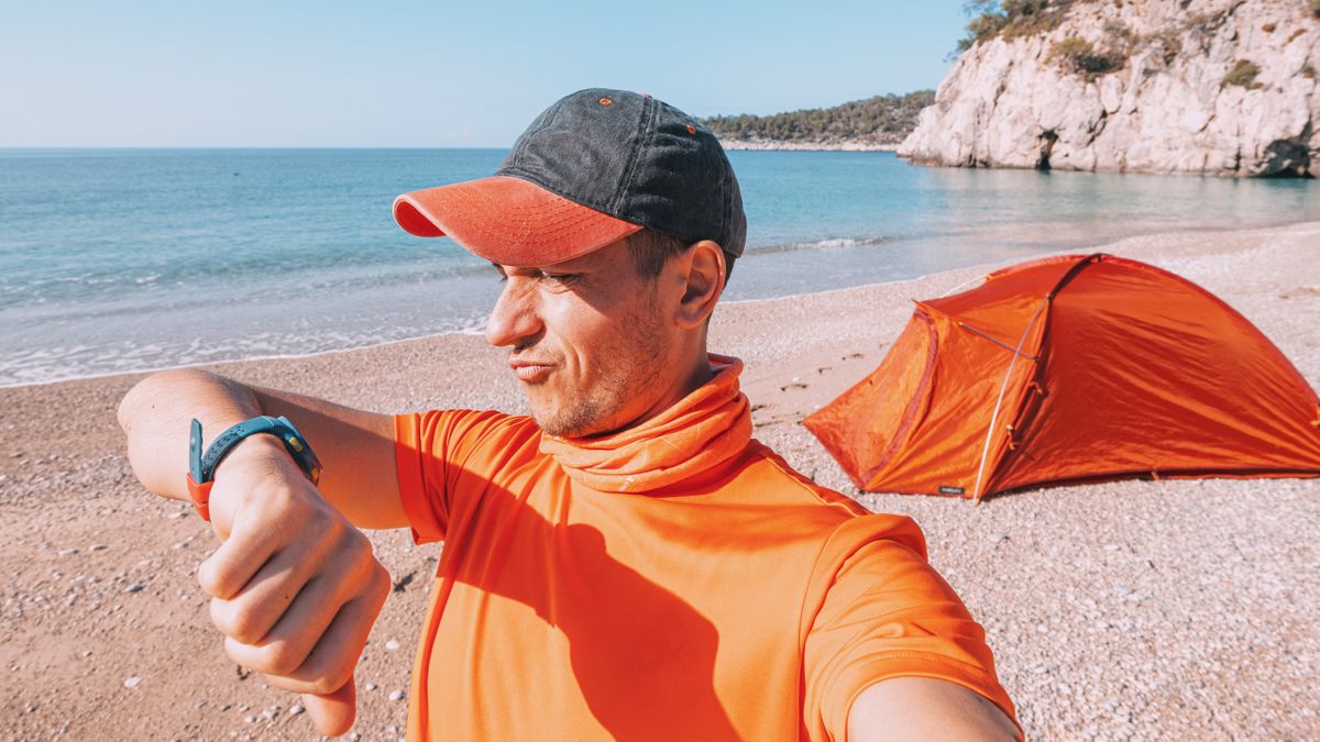 Man grimacing checking GPS watch