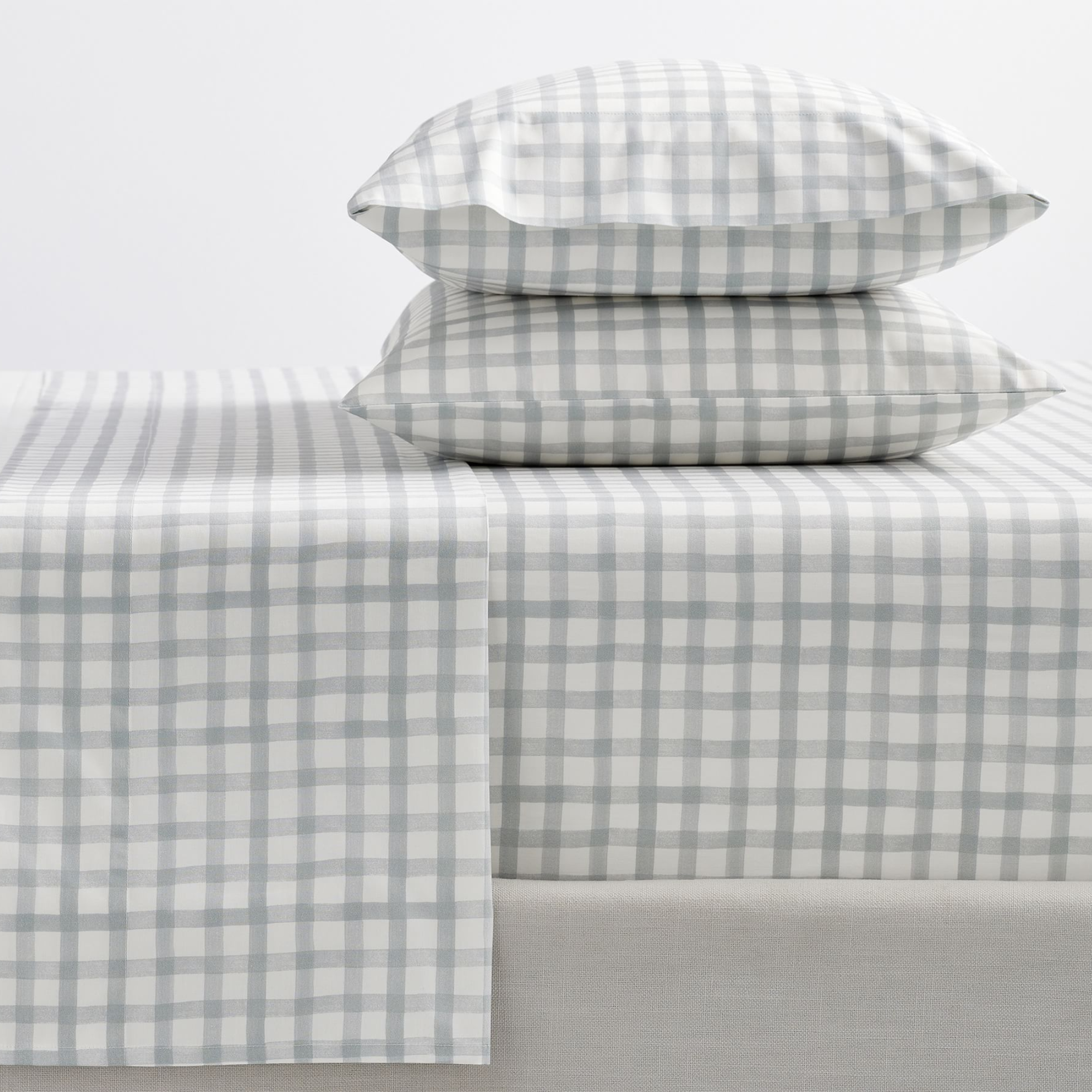 sheets and two pillows in white and gray plaid