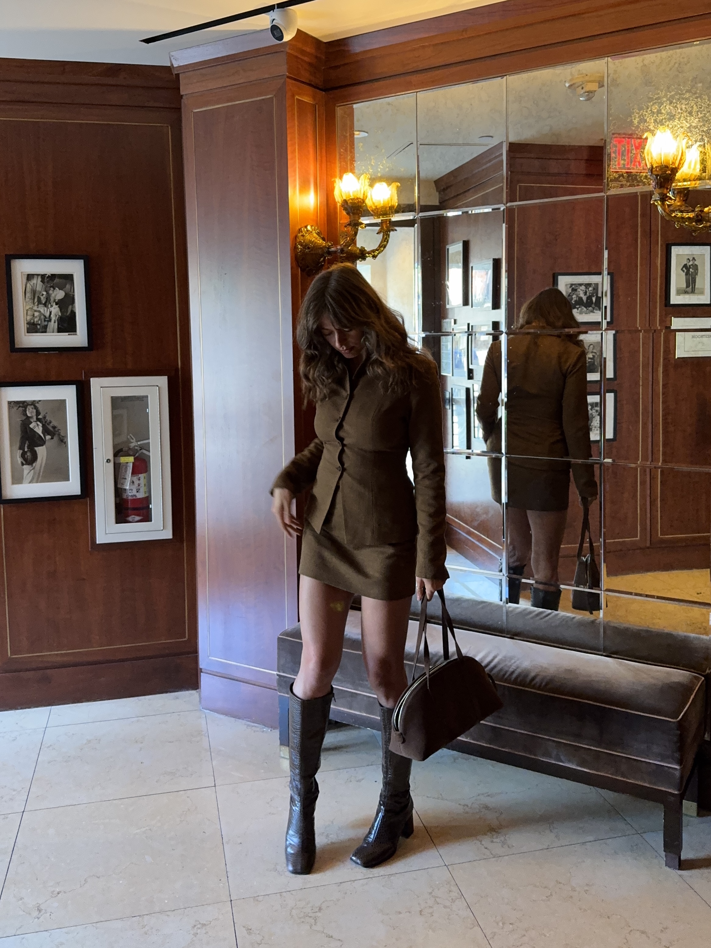 Kathryn Zahorak wearing brown matching set and knee high boots