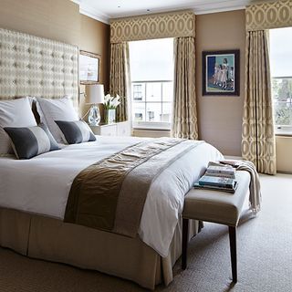 main bedroom with bed cushions and headboard fabric