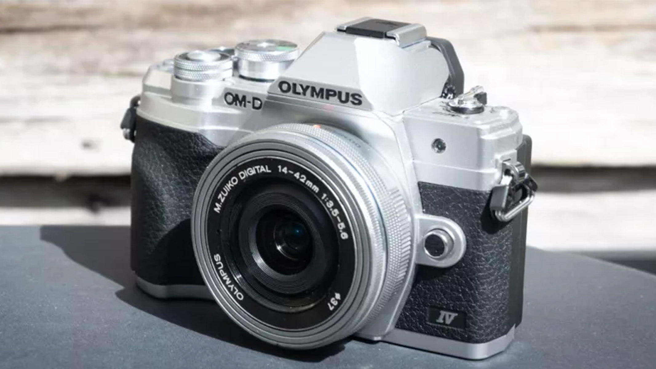 A front view of the Olympus OM-D E-M10 Mark IV resting on a table