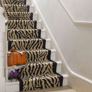 white staircase with animal print stair runnerBill Kingston