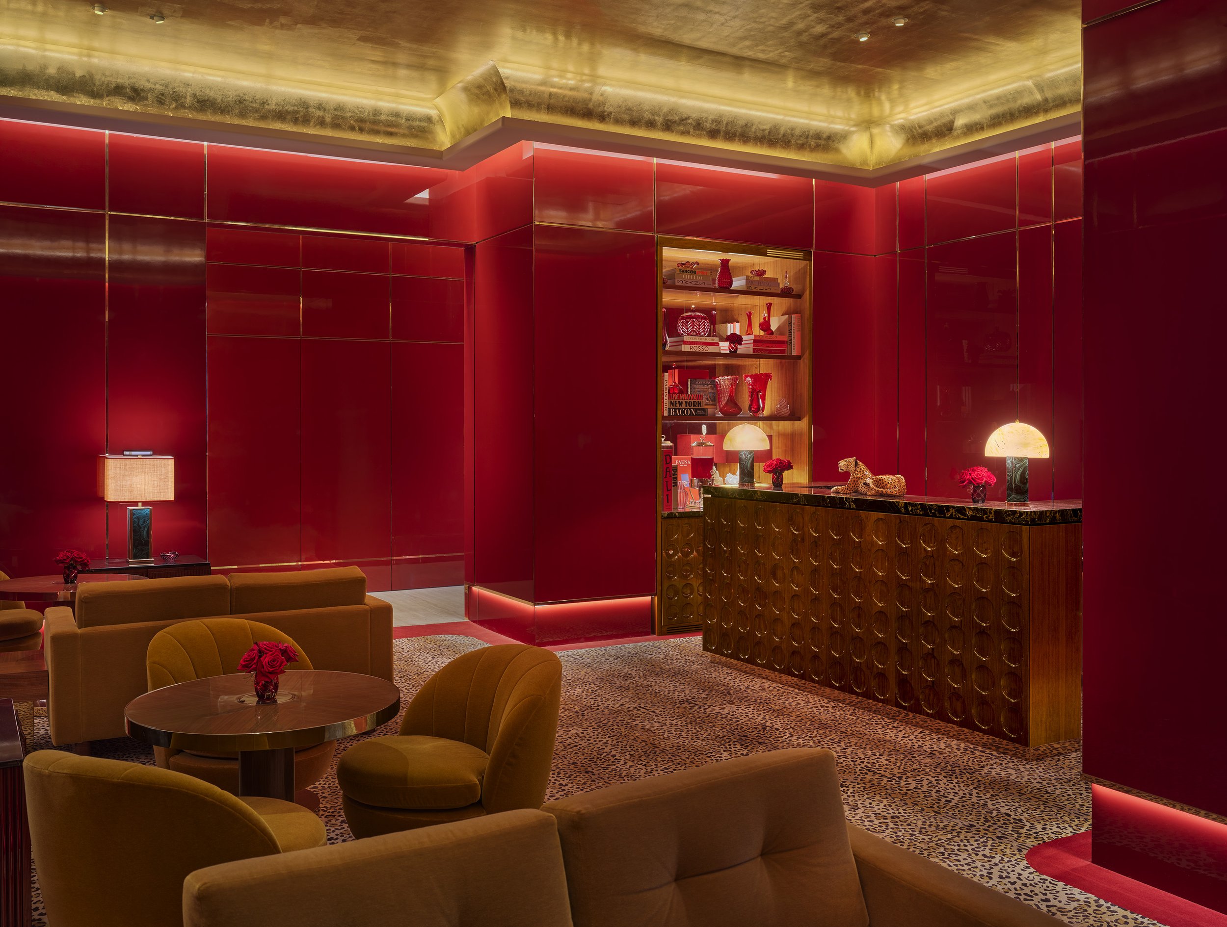 A spectacularly designed hotel&#039;s communal areas mix red, animal-print, or goldeny velvety fabrics with golden and brass surfaces, colourful artwork, theatrical chandeliers, and a retro-fuelled atmosphere.