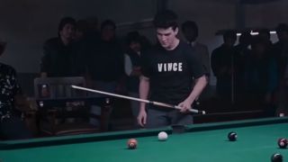 Tom Cruise playing pool, with a black t-shirt that says "Vince" in The Color Of Money