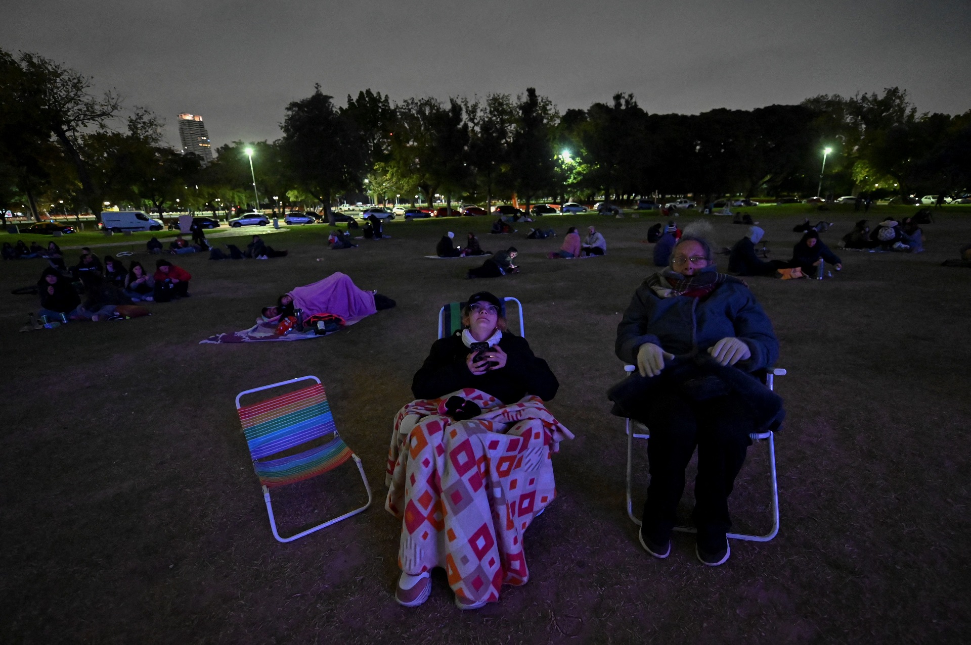 People look at the moon during a total lunar eclipse in Buenos Aires, on May 15 2022.