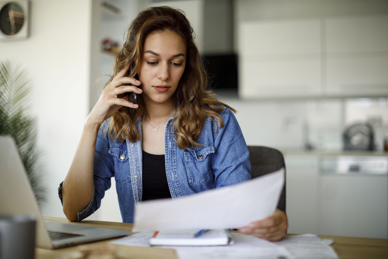 A woman calls the Financial Ombudsman Service about her bills