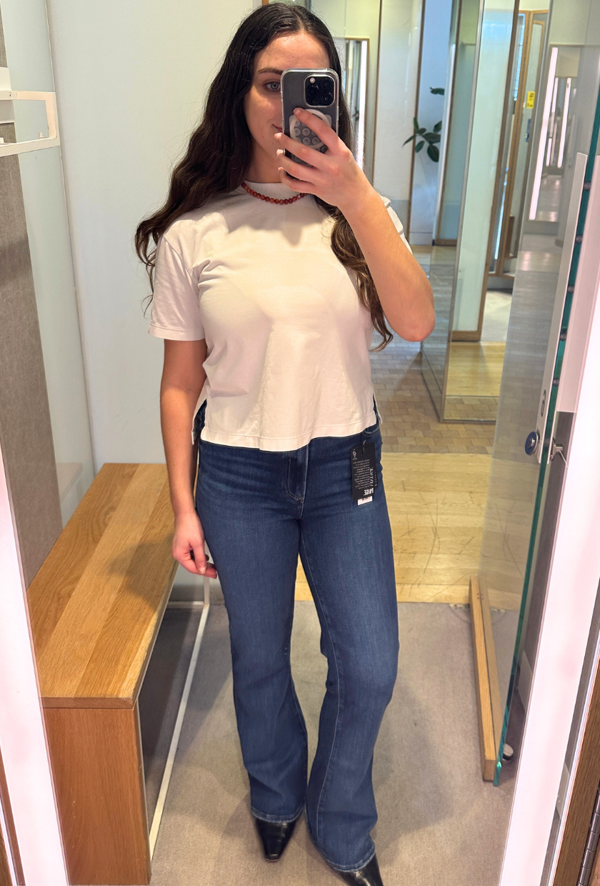An image of Who What Wear UK SEO Writer, Ava Gilchrist, wearing Paige bootcut jeans.