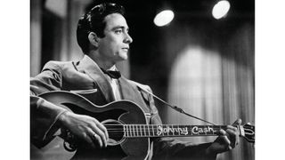Johnny Cash with his custom Gibson J-200, in 1957. Note the oversized pickguard.