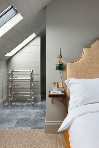 Bed in attic room painted Pigeon by Farrow & Ball