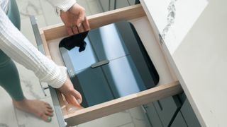 a photo of the Wyze Scale X being put in a drawer