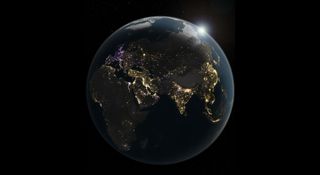 an illustration of earth at night. the planet is mostly black and in shadow, revealing patterns of dots of light tracing the outlines of continents