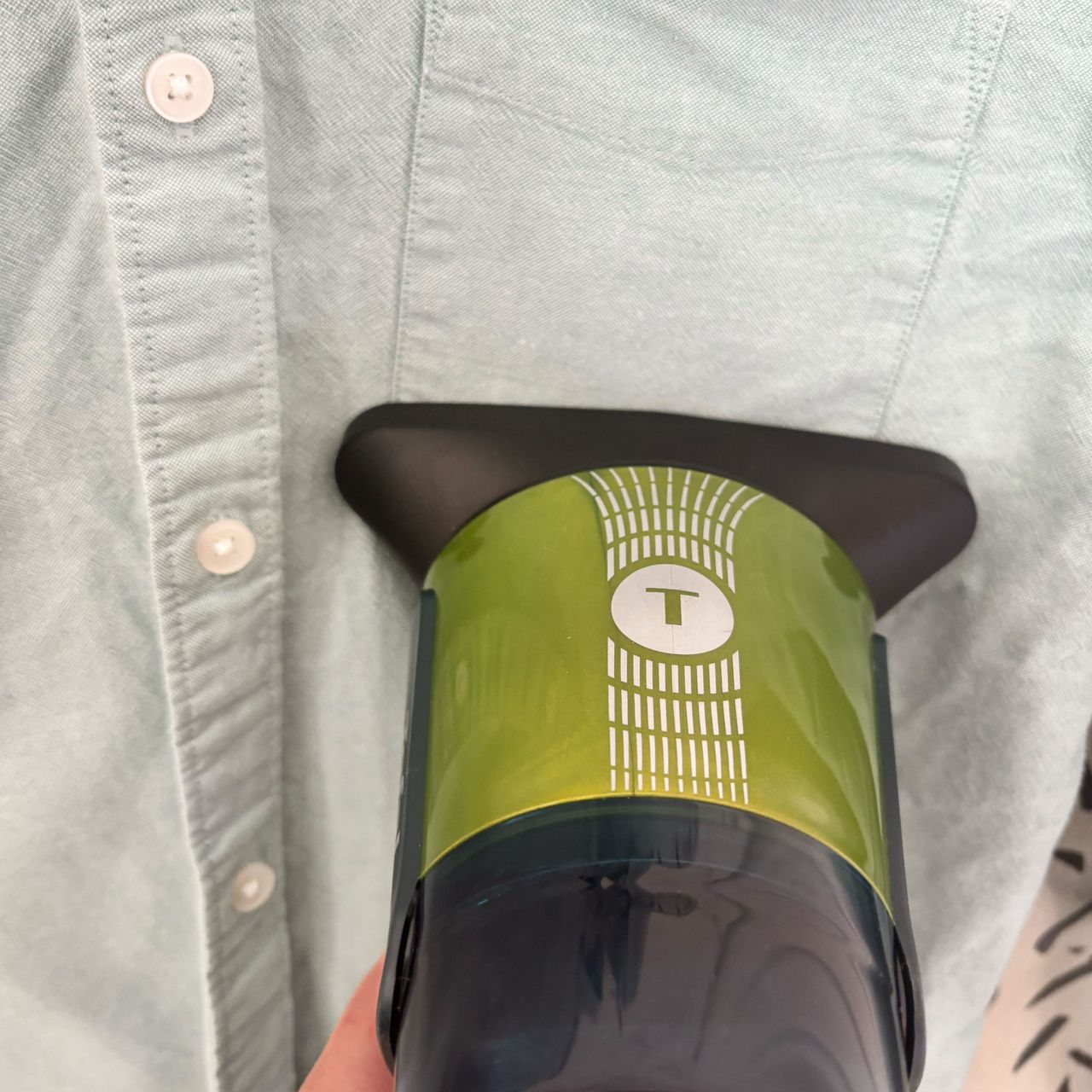 close up of Tefal aerosteam steamer on a green shirt