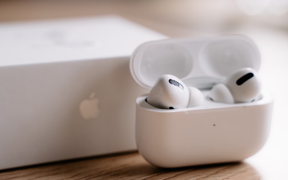 AirPods Pro 2 in their case which is open in front of a white box with an Apple logo on it