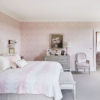 main bedroom with printed pink wallpaper