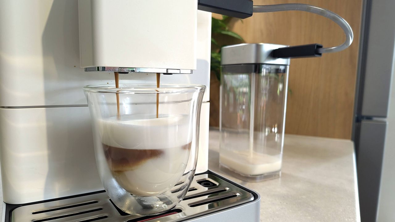 KitchenAid KF4 espresso machine dispensing coffee into macchiato