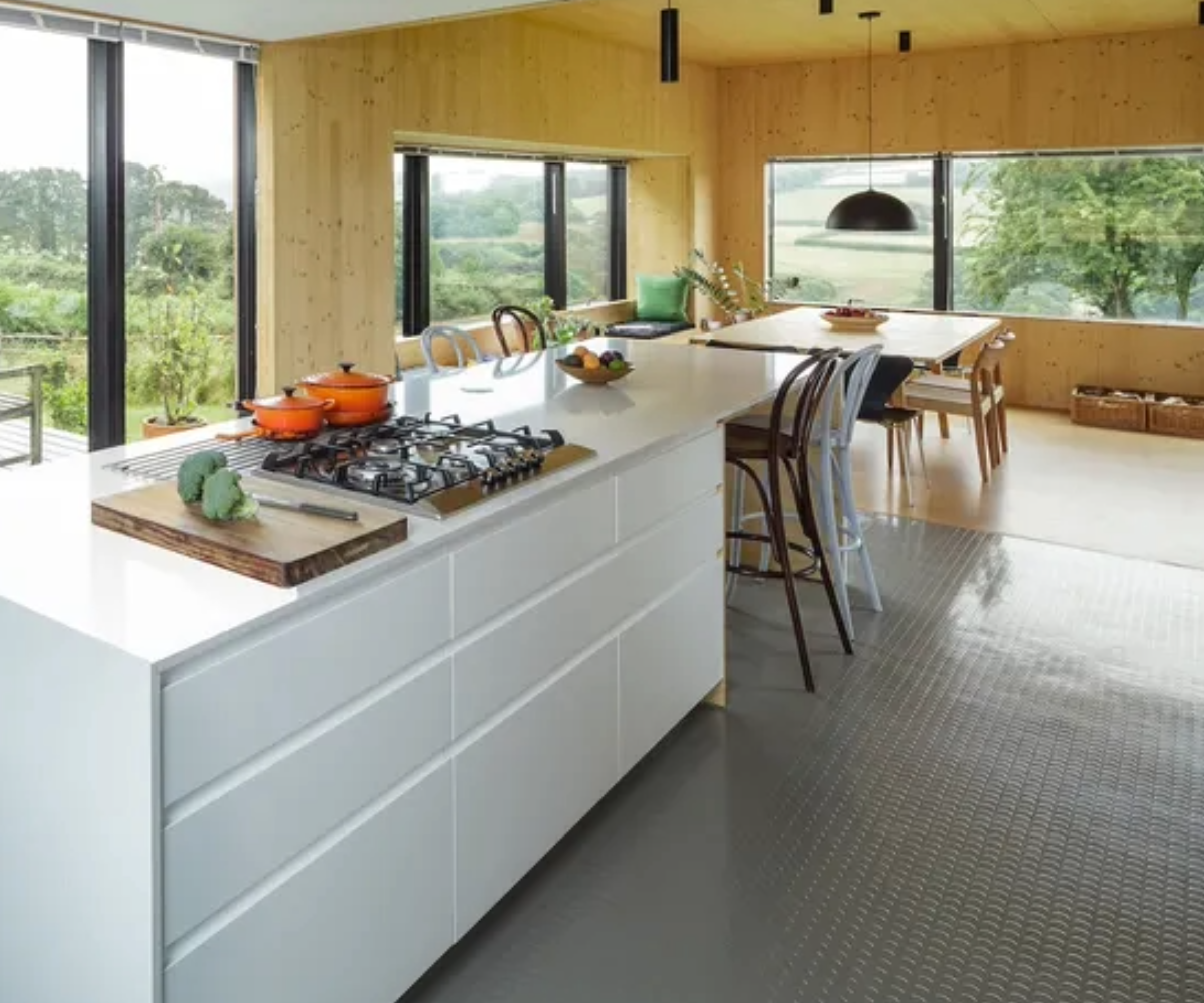 grey rubber flooring in white and wood kitchen