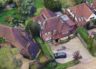 An overhead shot of the property shows a small driveway and large back garden