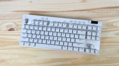 The Logitech G PRO X TKL Rapid gaming keyboard in white seen from above on a wood table