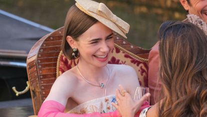 Lily Collins in a gondola in Venice, Italy. while filming "Emily in Paris."