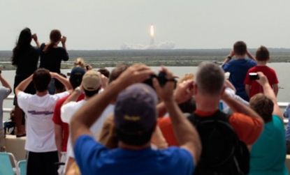 Spectators watch Friday as the space shuttle Atlantis launches for the final time.