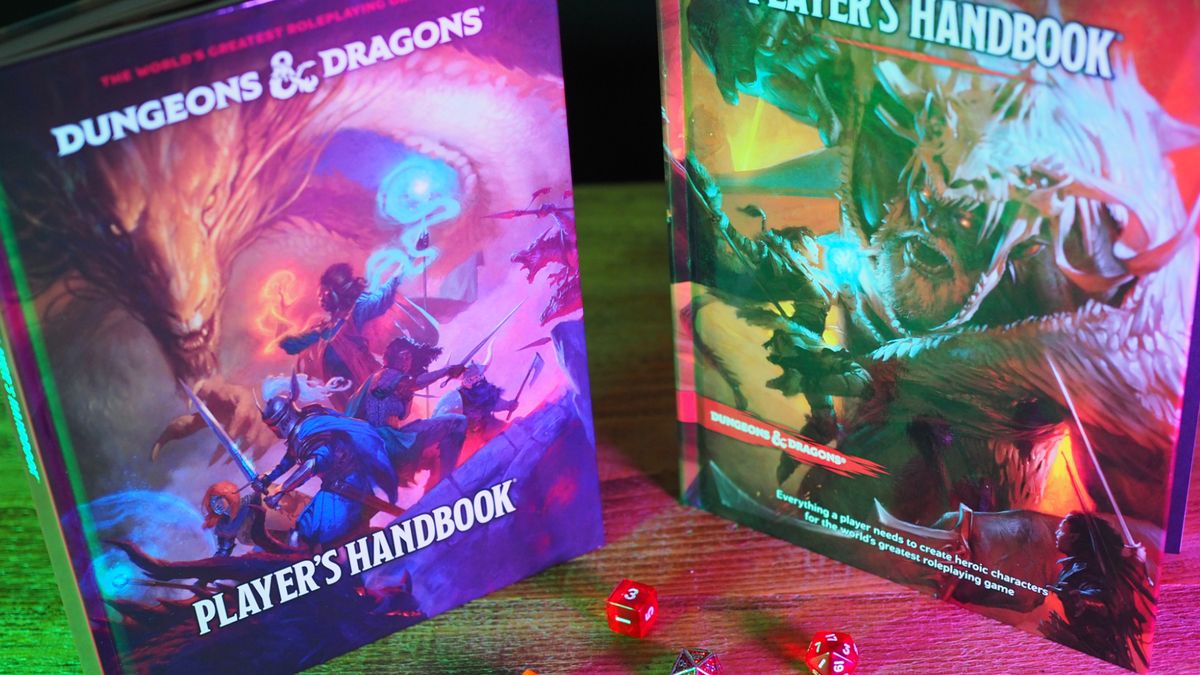 The new and old D&amp;D Player&#039;s Handbooks alongside one another on a wooden table, with dice in front of them