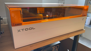 xTool S1 review; a white laser machine on a table