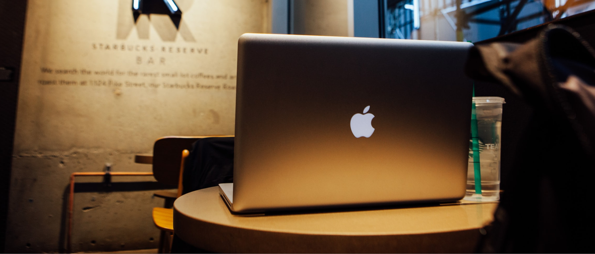 Writer&#039;s laptop on table in a coffee bar