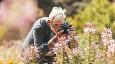 man taking a close up photo of a flower