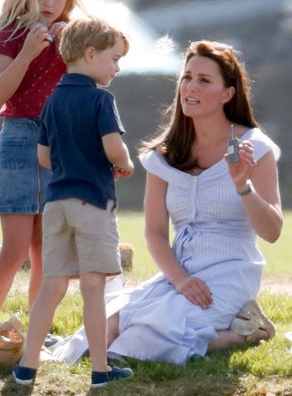 Kate Middleton on a hill talking to Prince George