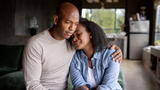 Man comforting his grieving partner