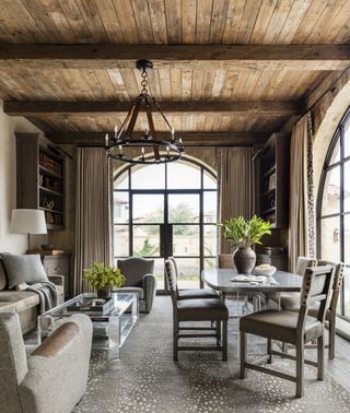 A traditional style living room with a chandelier above