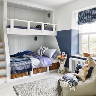 boys bedroom with built-in bunk beds, blue feature walls and cosy bean bag chair