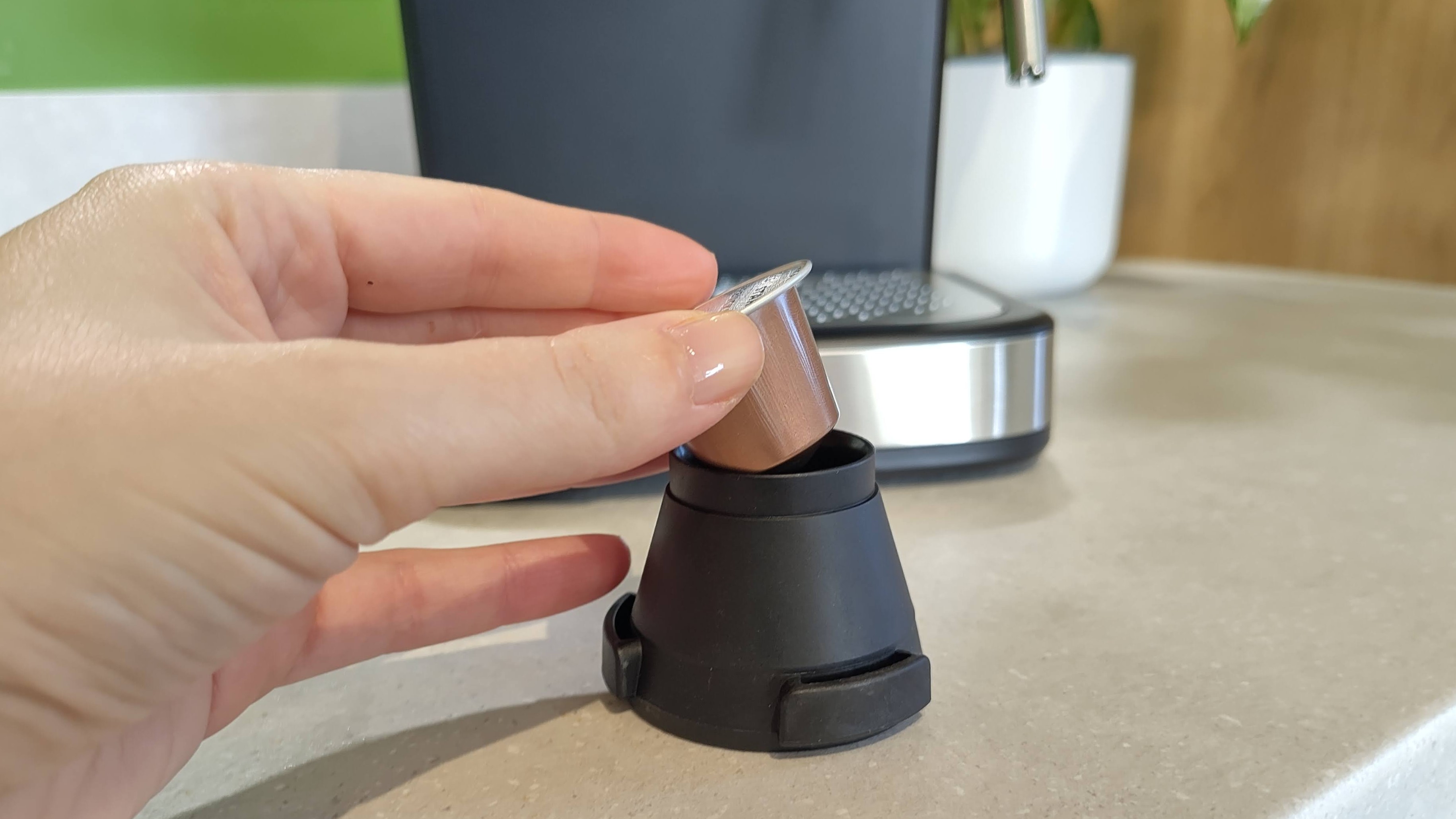 Person placing Nespresso capsule in Russell Hobbs Everyday Espresso Machine holder