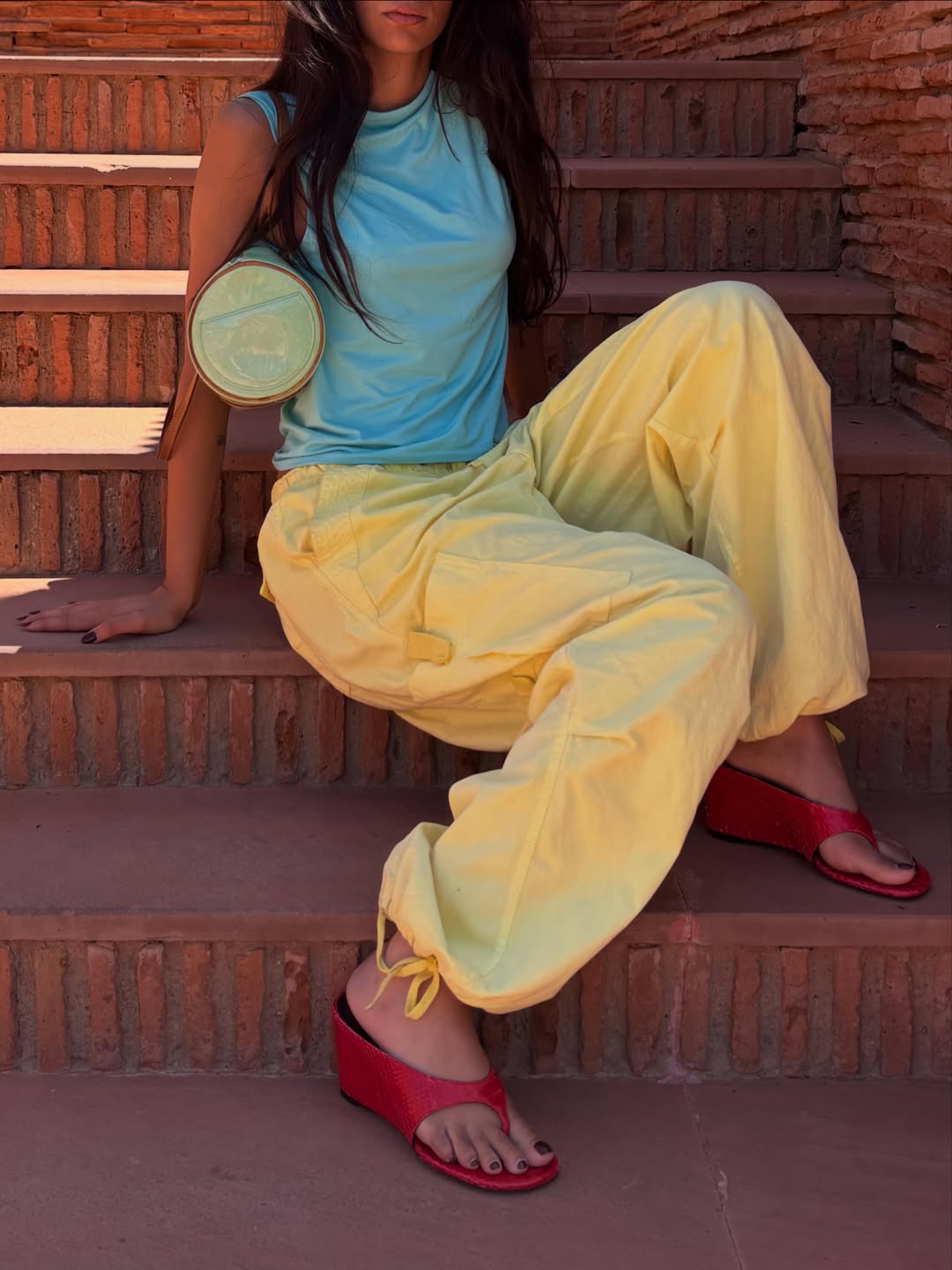 Fashion influencer wearing wedge flip-flops.