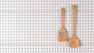 how to store camping gear: cooking utensils on a peg board