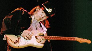 Stevie Ray Vaughan playing guitar onstage