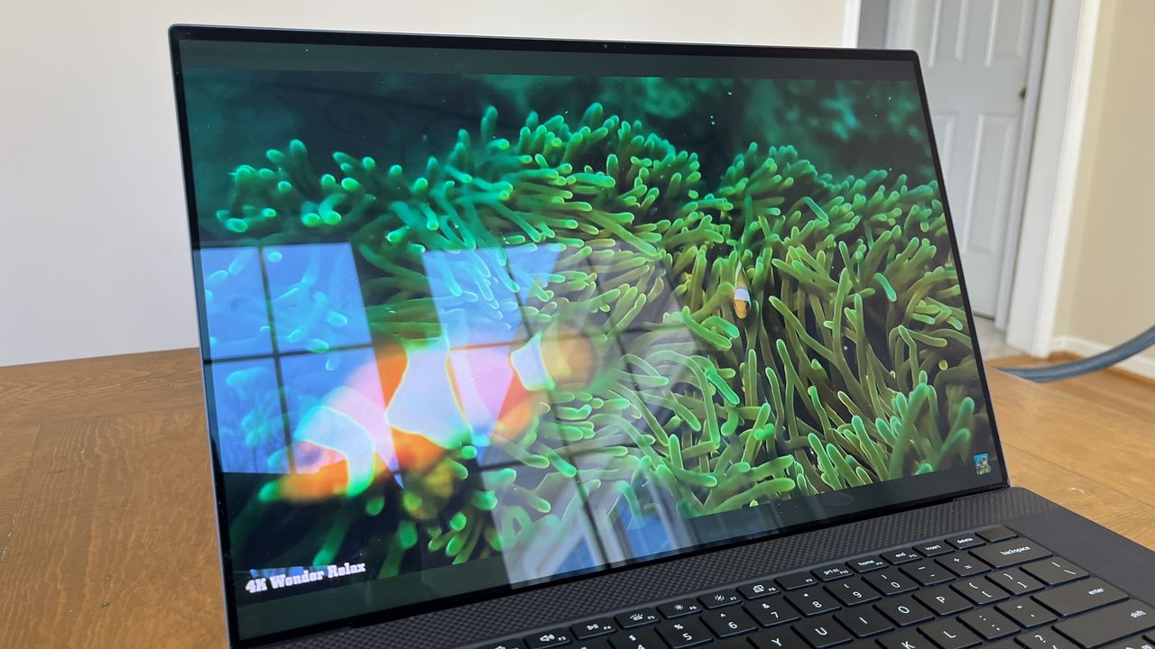 Dell XPS 17 laptop in use on a wooden desk