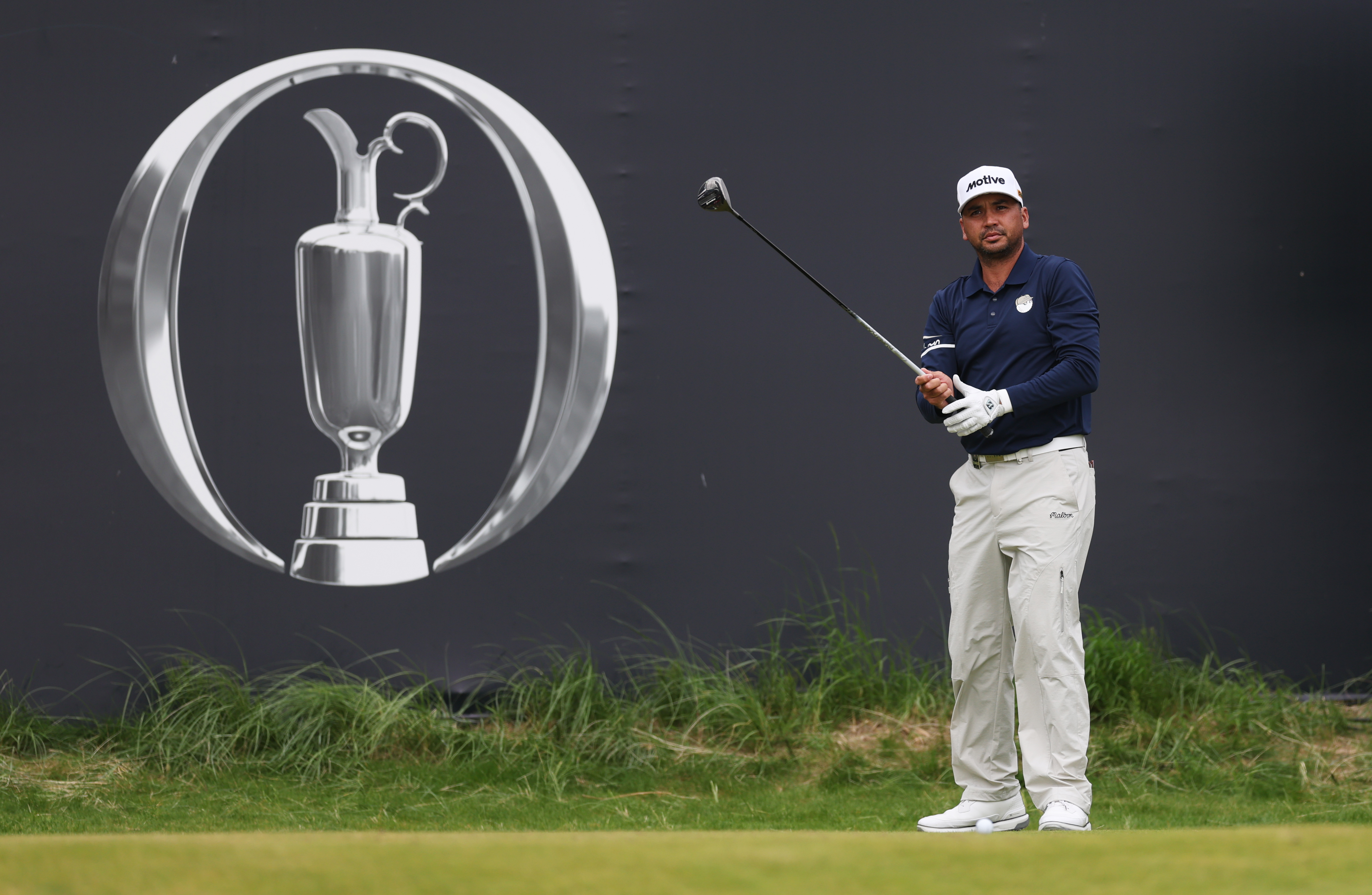 Jason Day tees it up in front of an Open Championship logo