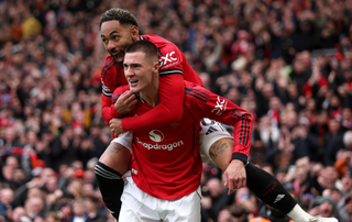 Benjamin Sesko of Manchester United celebrates scoring his team's third goal with teammate Matheus Cunha during the Premier League match between Manchester United and Aston Villa at Old Trafford on March 15, 2026 in Manchester, England. 