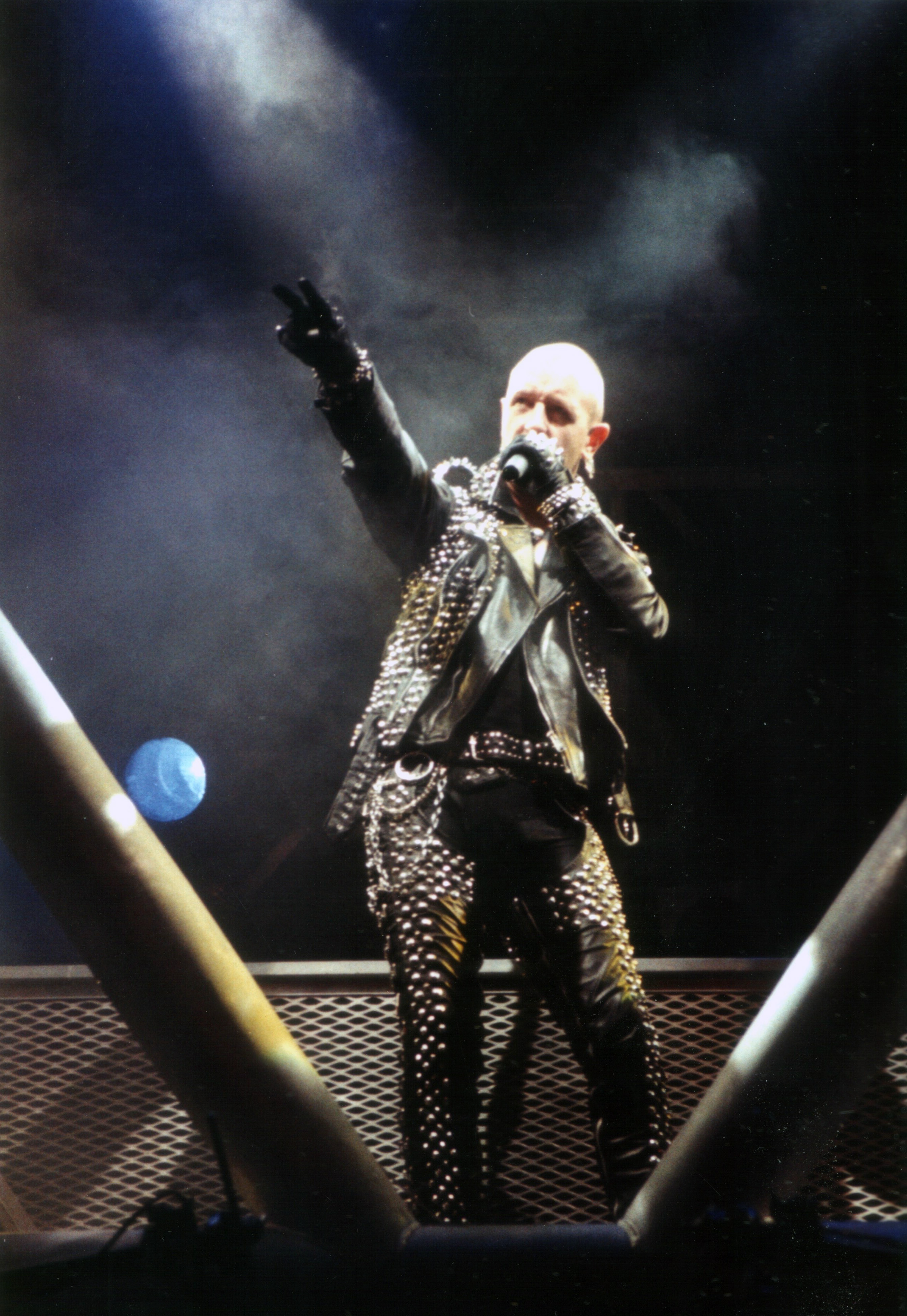 Rob Halford on stage, pointing to the crowd