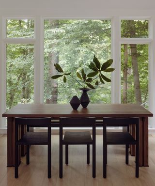 eat-in kitchen dining nook with large windows and views of trees