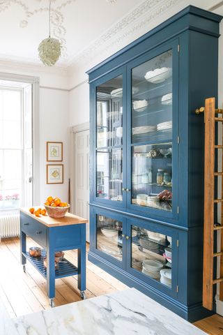 blue kitchen dresser with glass front and blue kitchen butcher's block