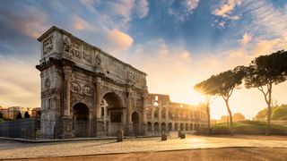 Arch of Constantine with the Colosseum at sunrise
