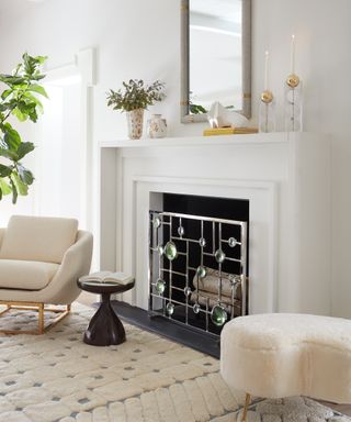A modern fireplace idea by Jonathan Adler in Living room with Globo fire screen and Beaumont chair